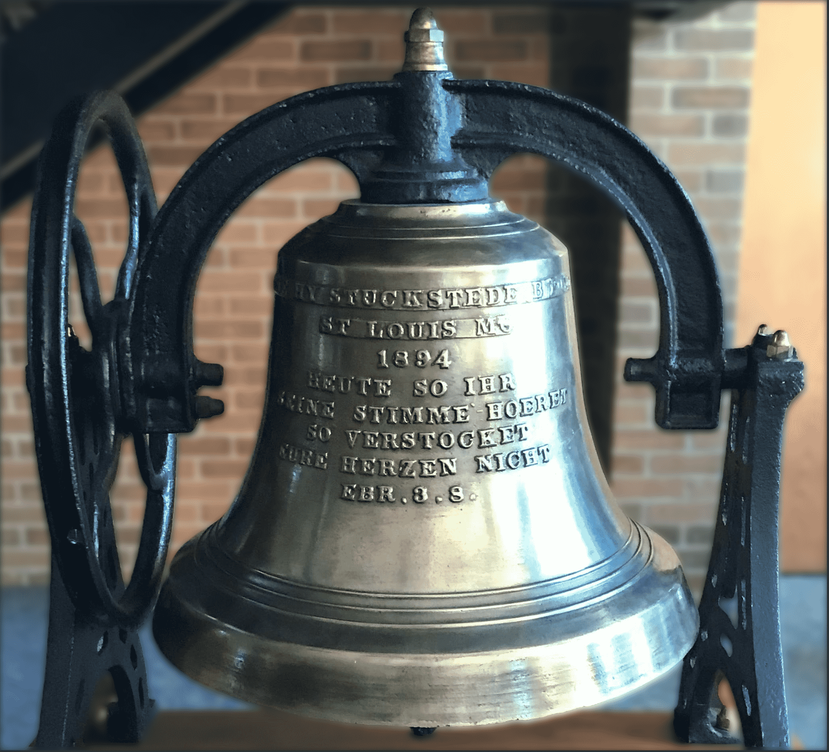 a close up of a large metal bell with writing on it